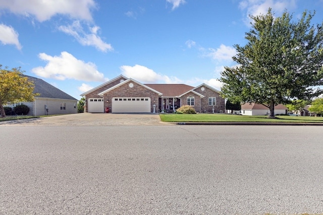 ranch-style house featuring a front lawn and a garage