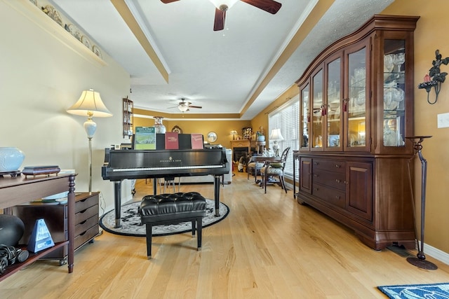 misc room with ceiling fan and light wood-type flooring