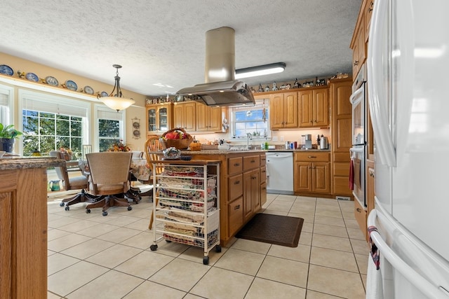 kitchen featuring white appliances, island range hood, light tile patterned floors, pendant lighting, and a center island