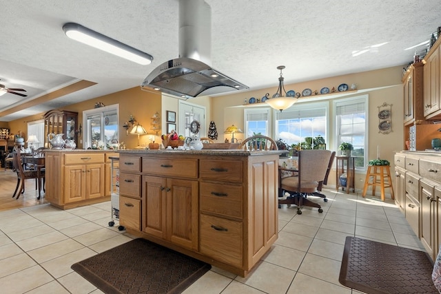 kitchen with island exhaust hood, pendant lighting, a center island, and ceiling fan