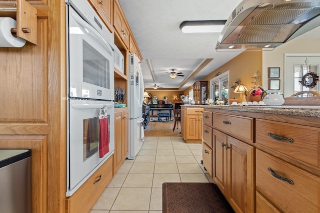 kitchen with white appliances, ceiling fan, and light tile patterned floors