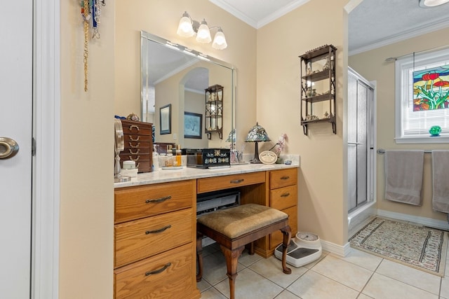 bathroom with vanity, a shower with door, tile patterned floors, and crown molding