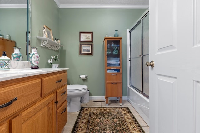 full bathroom with vanity, tile patterned flooring, combined bath / shower with glass door, ornamental molding, and toilet