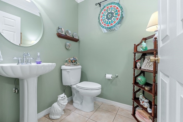 bathroom featuring ornamental molding, toilet, and tile patterned floors