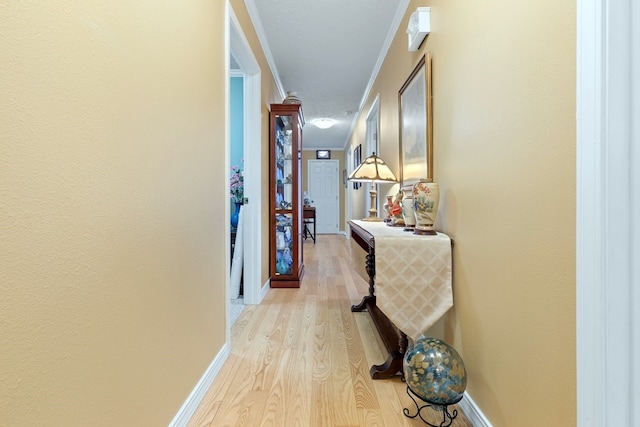 hallway featuring light hardwood / wood-style floors and ornamental molding