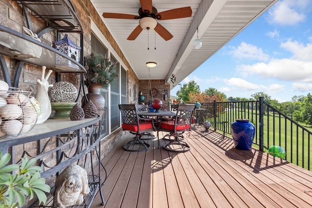 deck featuring a lawn and ceiling fan