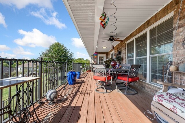 wooden terrace featuring ceiling fan