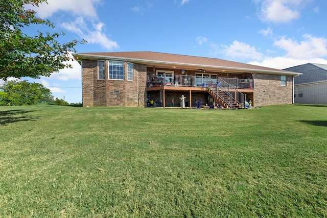 back of property featuring a deck and a lawn