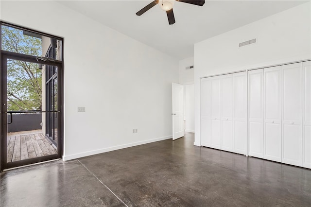 unfurnished bedroom featuring concrete flooring, multiple closets, visible vents, and baseboards