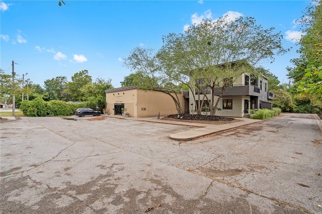 exterior space featuring uncovered parking and stucco siding