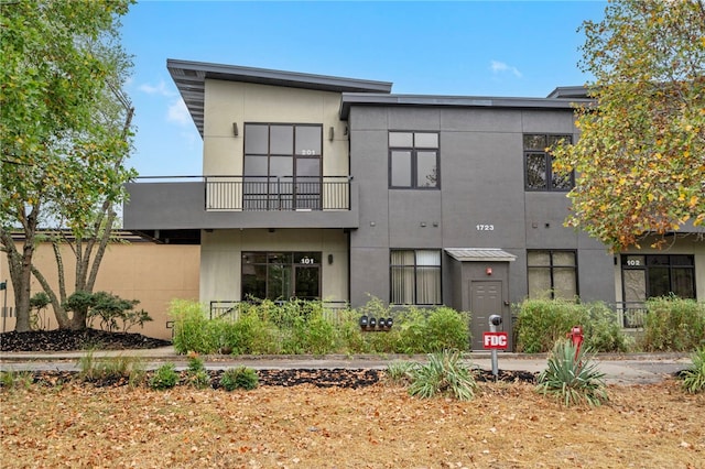 exterior space featuring a balcony and stucco siding