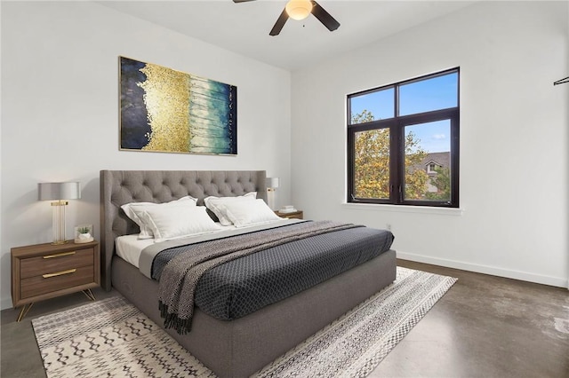 bedroom featuring ceiling fan, concrete floors, and baseboards