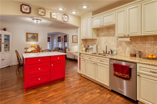 kitchen featuring cream cabinetry, stainless steel dishwasher, sink, and dark wood-type flooring