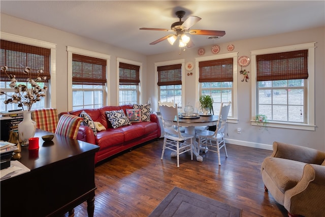 living room with ceiling fan and dark hardwood / wood-style flooring