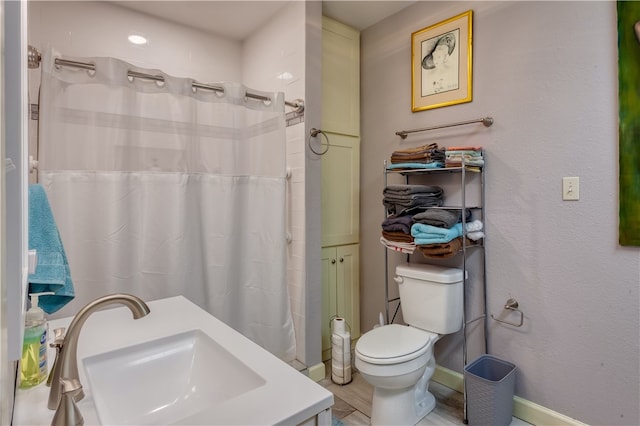 bathroom featuring walk in shower, vanity, and toilet