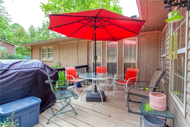 wooden deck featuring a grill