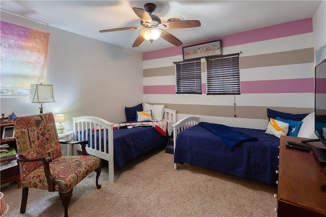 bedroom with ceiling fan and light colored carpet