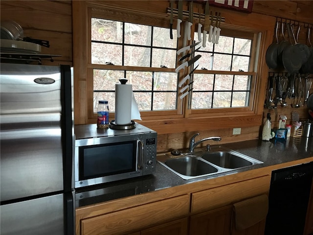 kitchen with stainless steel appliances, a wealth of natural light, and sink