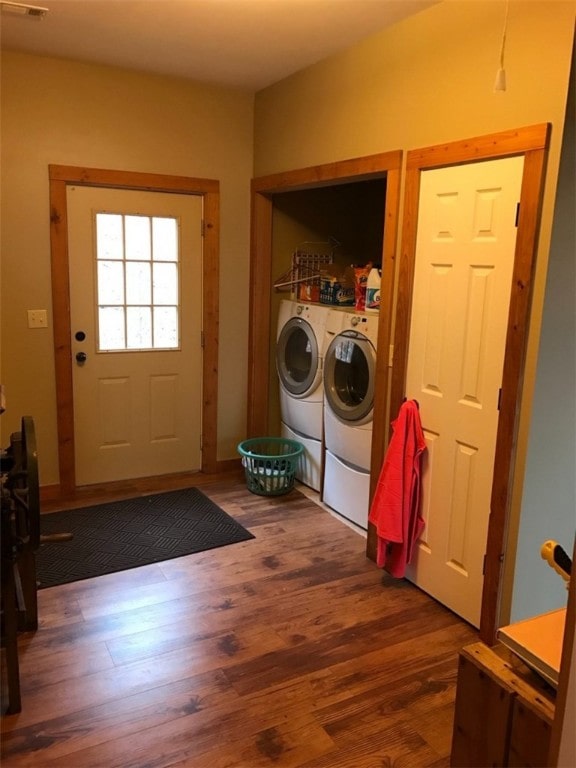 laundry area featuring washer and clothes dryer and dark wood-type flooring