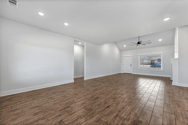 unfurnished living room with dark wood-type flooring, visible vents, ceiling fan, and baseboards