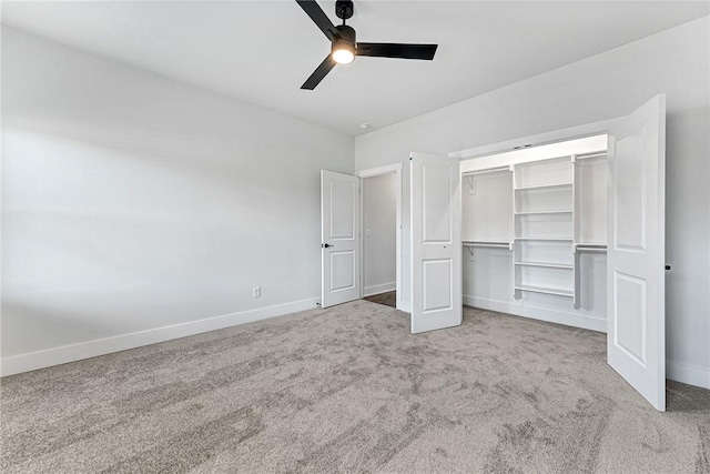 unfurnished bedroom featuring ceiling fan, a closet, carpet, and baseboards