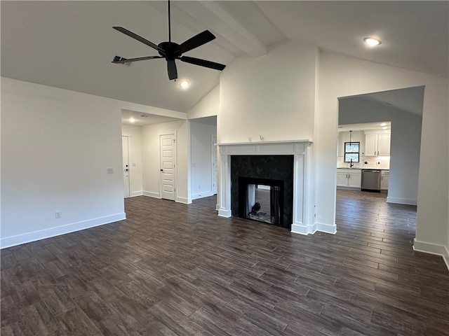 unfurnished living room featuring ceiling fan, sink, a fireplace, and dark hardwood / wood-style flooring