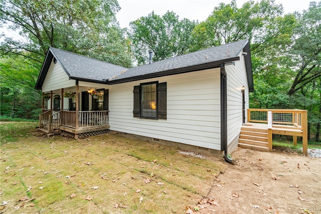 exterior space featuring a wooden deck and a yard