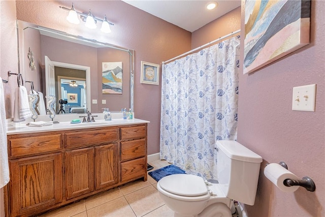 bathroom featuring toilet, vanity, and tile patterned flooring