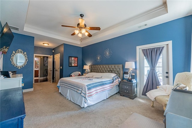 bedroom with ceiling fan, carpet, a tray ceiling, and a closet