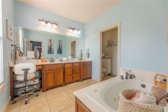 bathroom featuring tile patterned floors, vanity, toilet, and a tub to relax in