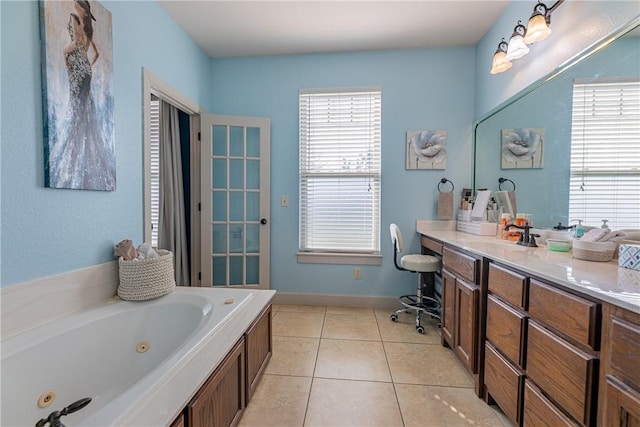 bathroom with tile patterned floors, a bathtub, and vanity