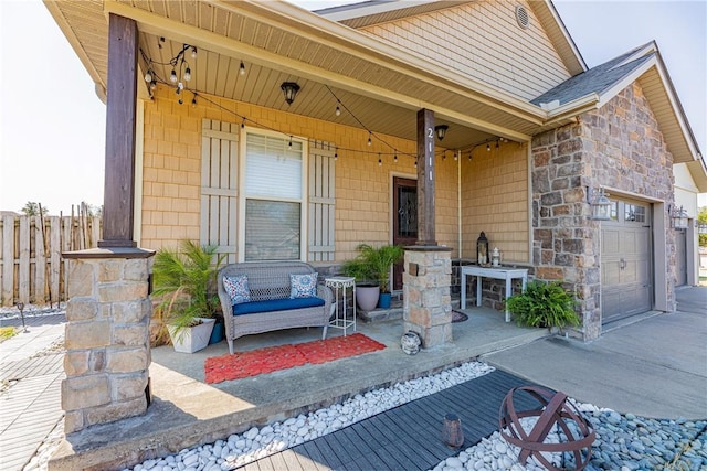 doorway to property featuring covered porch and a garage