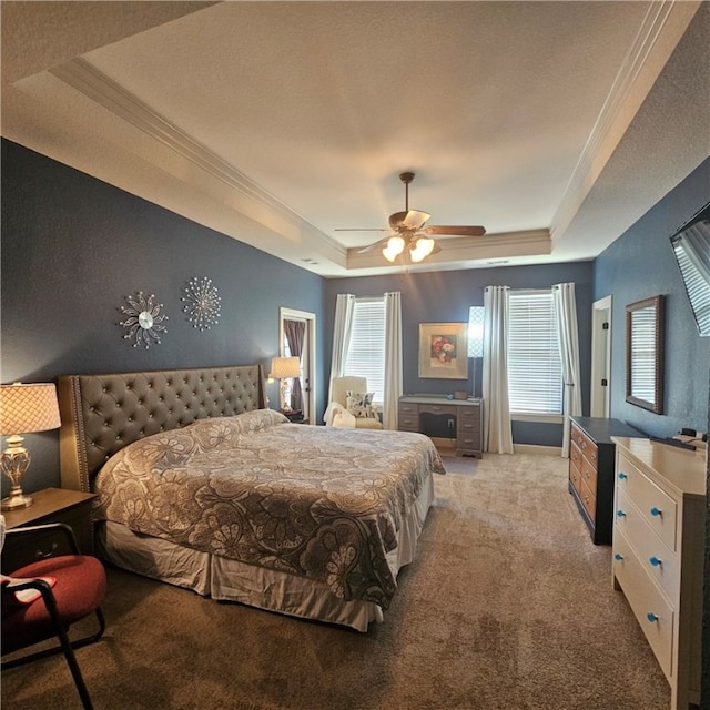 bedroom with ceiling fan, light colored carpet, and a raised ceiling