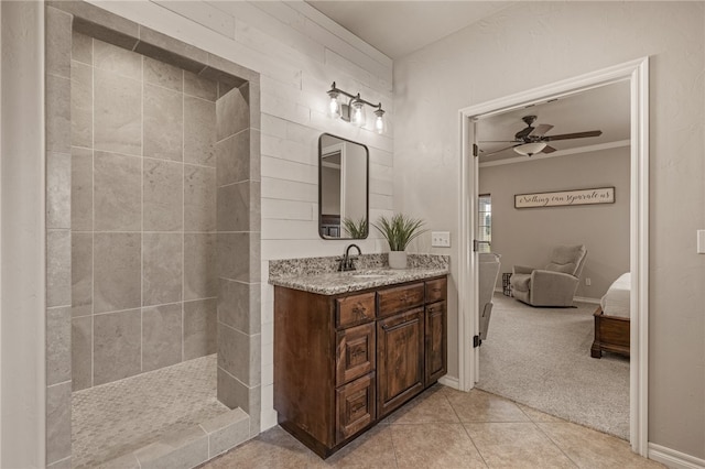 bathroom featuring vanity, walk in shower, tile patterned flooring, ceiling fan, and ornamental molding