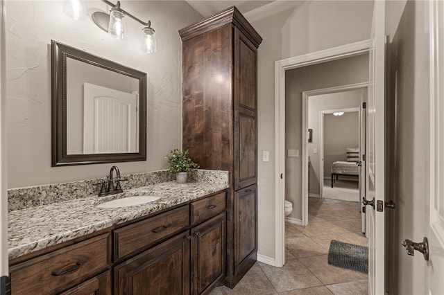 bathroom with vanity, tile patterned flooring, and toilet