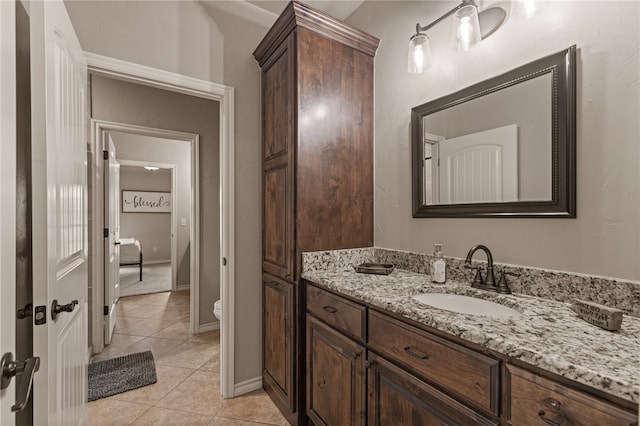 bathroom featuring tile patterned floors, vanity, and toilet