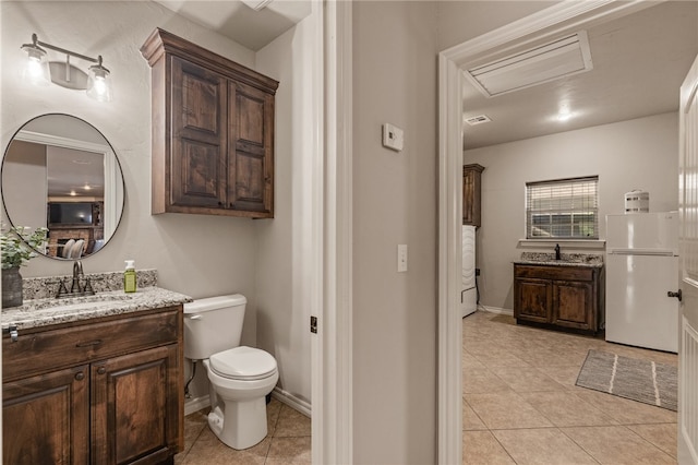 bathroom featuring tile patterned floors, vanity, and toilet