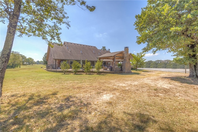 back of house with a lawn