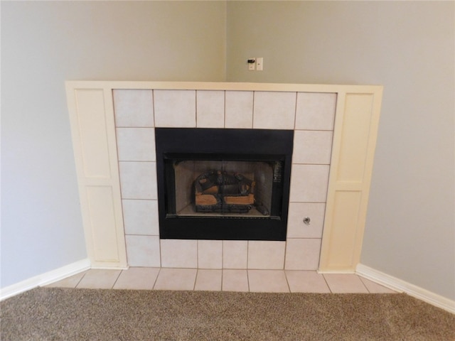 room details featuring a tile fireplace and tile patterned floors