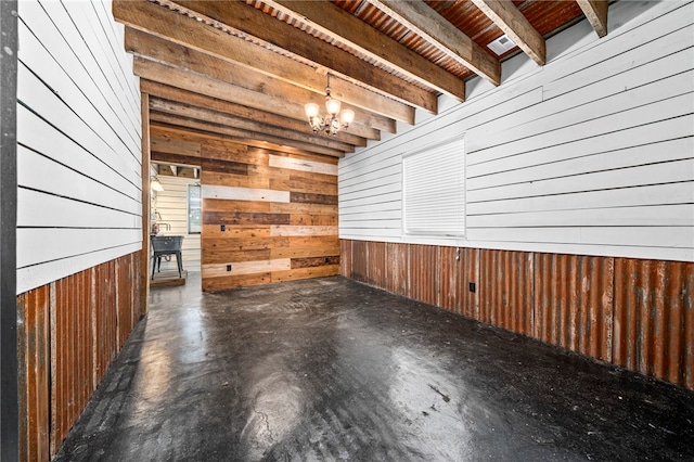 interior space with a notable chandelier and wood walls