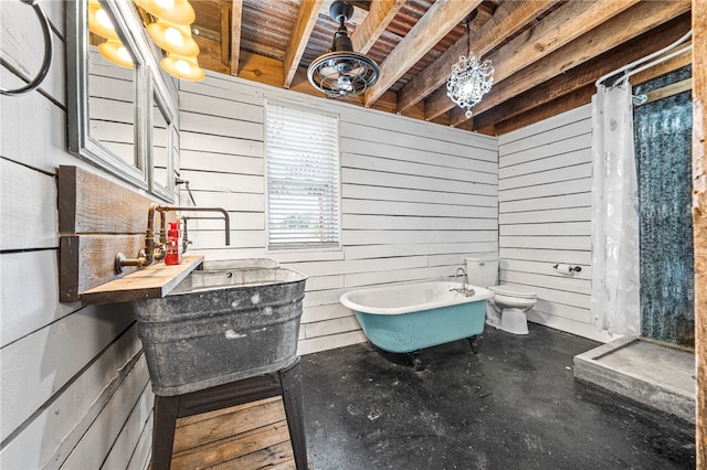 bathroom featuring wooden walls, curtained shower, and toilet