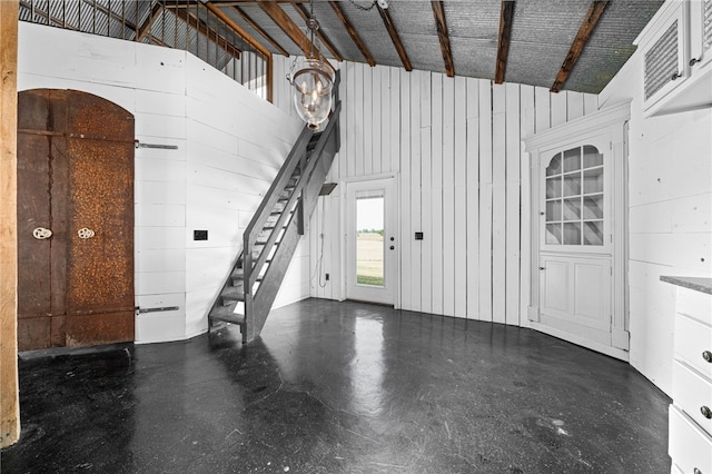 foyer with high vaulted ceiling and beamed ceiling