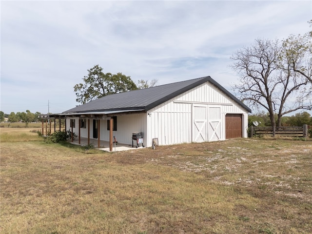 view of outbuilding featuring a yard