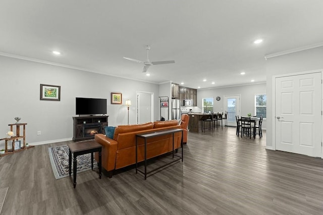 living room with ceiling fan, ornamental molding, recessed lighting, baseboards, and dark wood-style floors