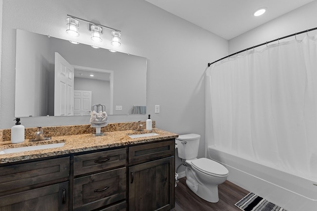 full bathroom with wood-type flooring, shower / bath combination with curtain, vanity, and toilet