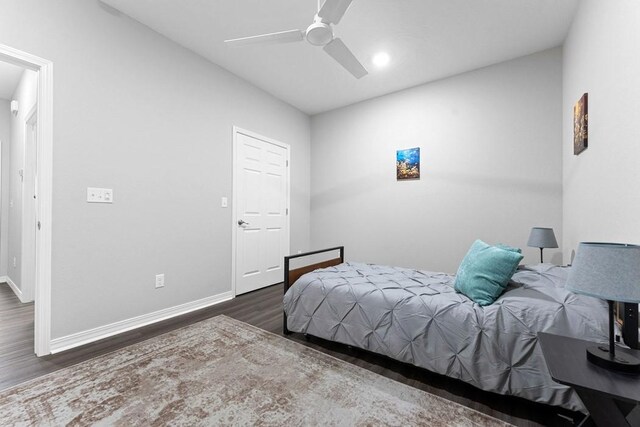 bedroom with wood finished floors, baseboards, and a ceiling fan