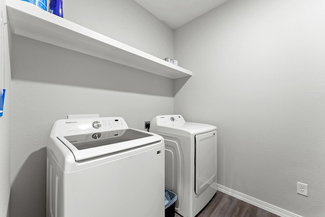 washroom featuring washer and clothes dryer and dark wood-type flooring