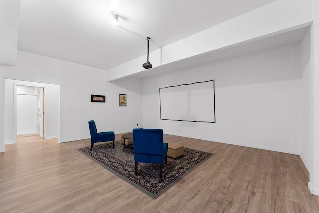 sitting room with baseboards and wood finished floors