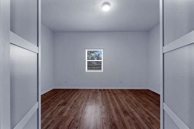 unfurnished bedroom with baseboards and wood finished floors