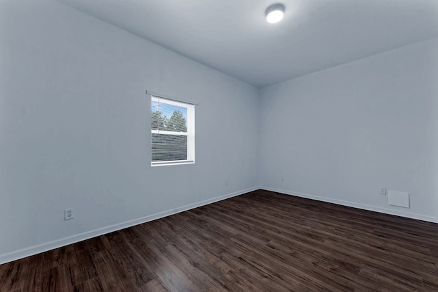 unfurnished room featuring dark wood-type flooring